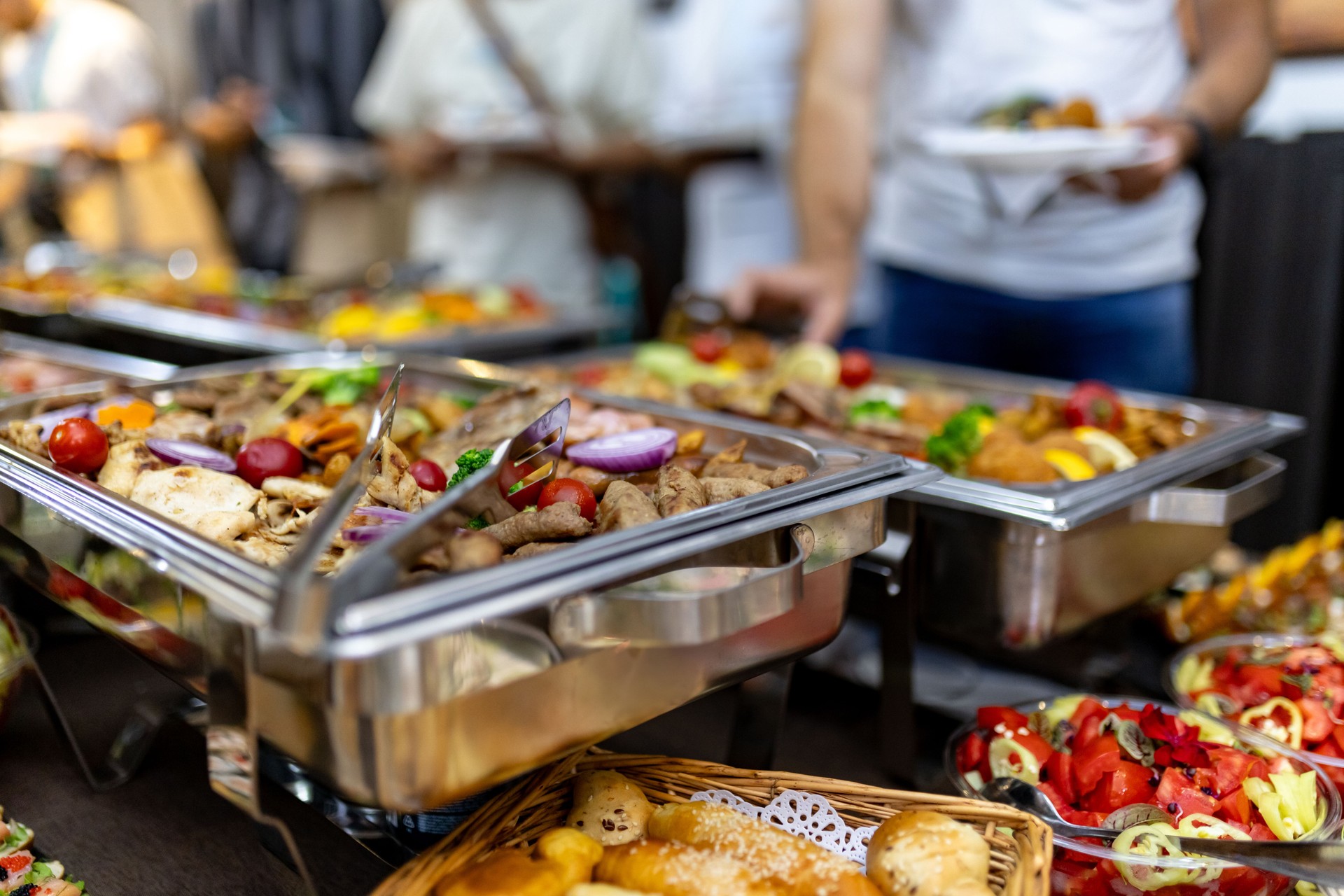 A vibrant buffet featuring a variety of grilled meats, fresh vegetables, and colorful side dishes at a summer festival gathering